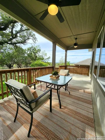 a view of a patio with a table chairs and a garden