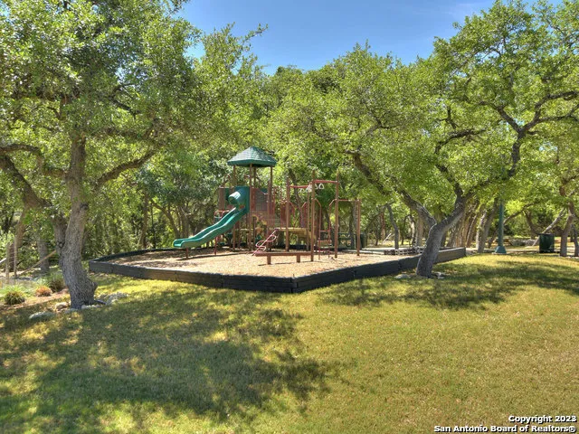 a backyard of a house with lots of green space and lake view