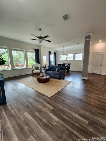 a living room with furniture and wooden floor
