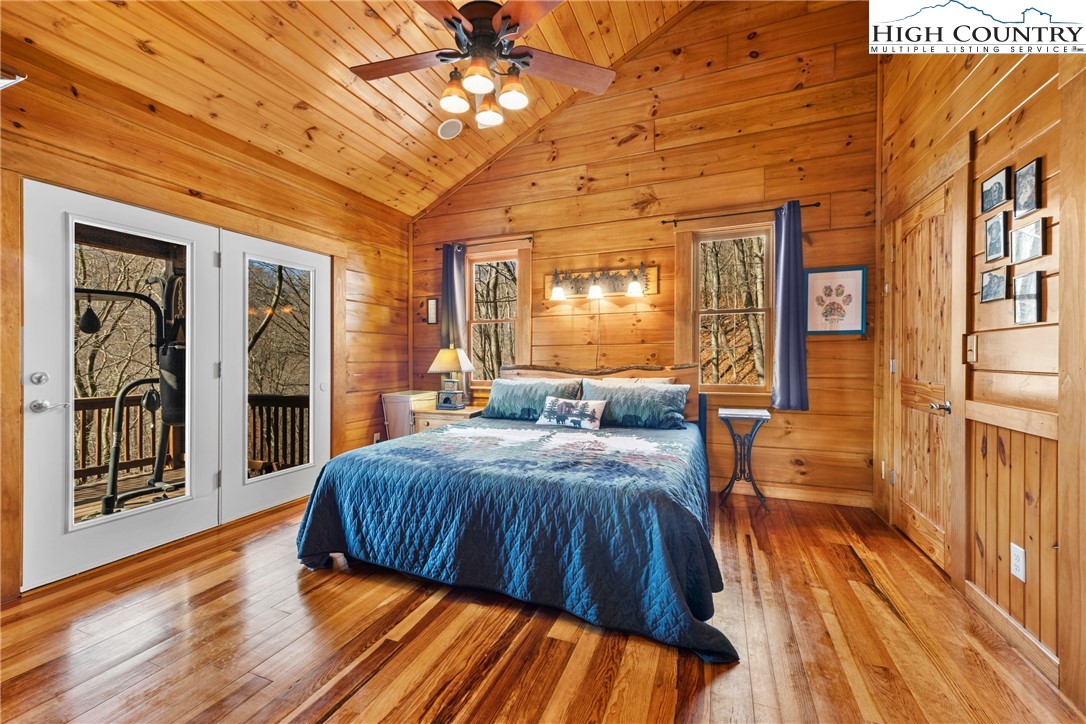 217 Rainbow Ridge Road Zionville, NC 28698 - Photo 22 of 46 a spacious bedroom with a bed and wooden floor