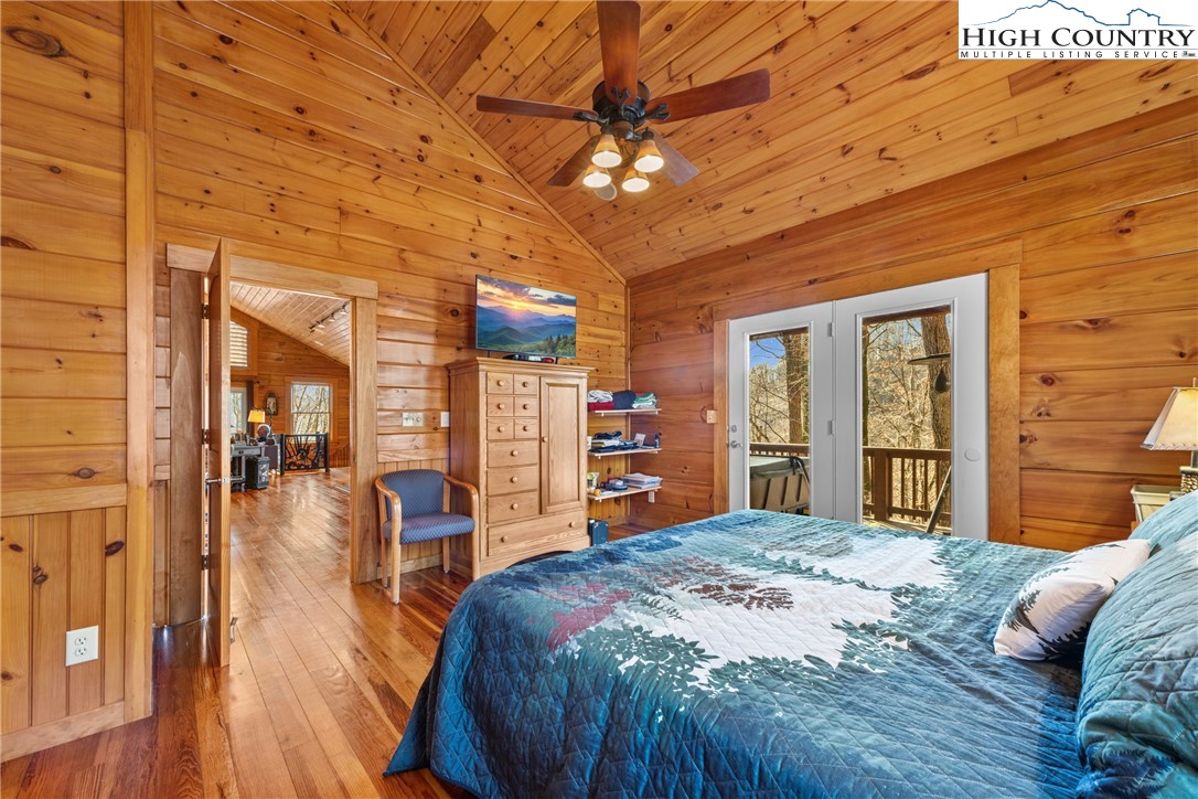 217 Rainbow Ridge Road Zionville, NC 28698 - Photo 23 of 46 a bedroom with a large bed and a large window