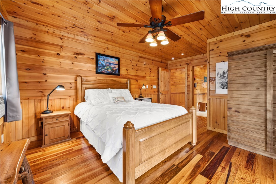 217 Rainbow Ridge Road Zionville, NC 28698 - Photo 32 of 46 a spacious bedroom with a bed and a table