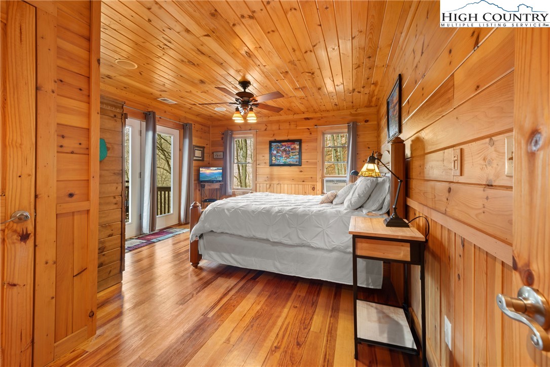 217 Rainbow Ridge Road Zionville, NC 28698 - Photo 33 of 46 a bedroom with a bed and wooden floor