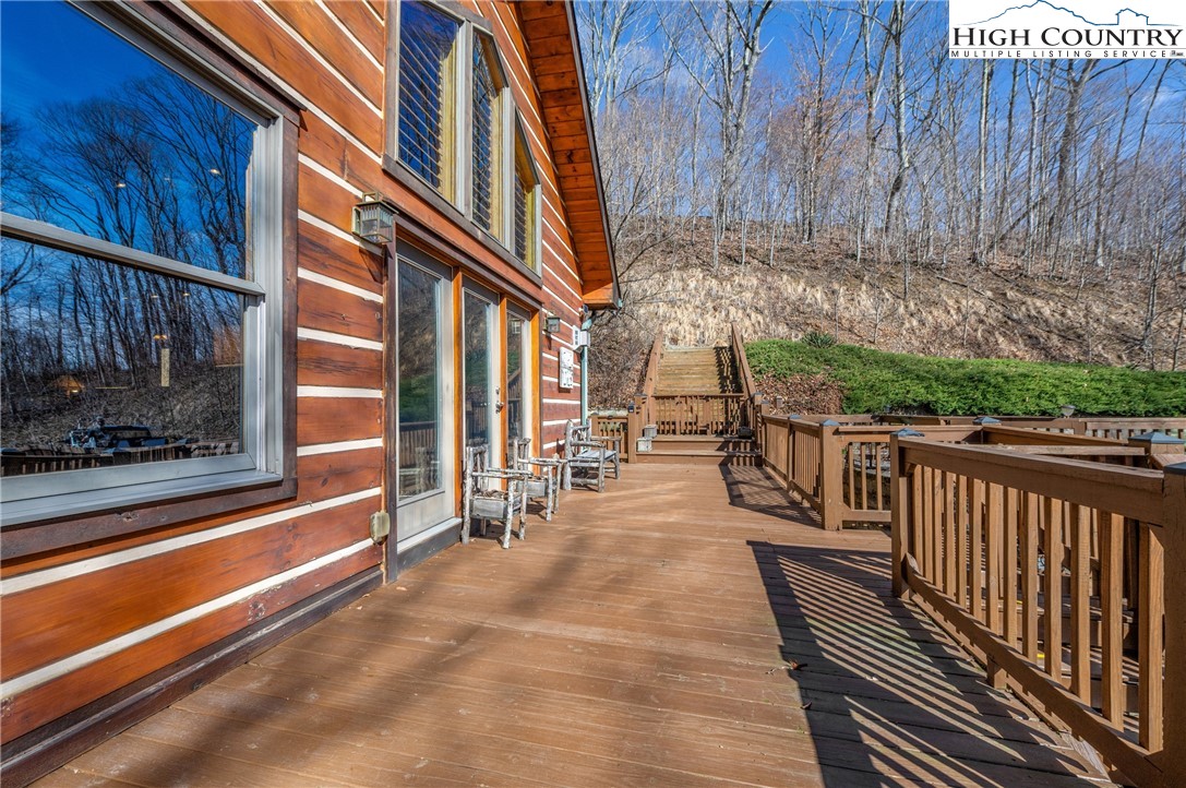 217 Rainbow Ridge Road Zionville, NC 28698 - Photo 7 of 46 a view of a patio with a table and chairs and wooden floor