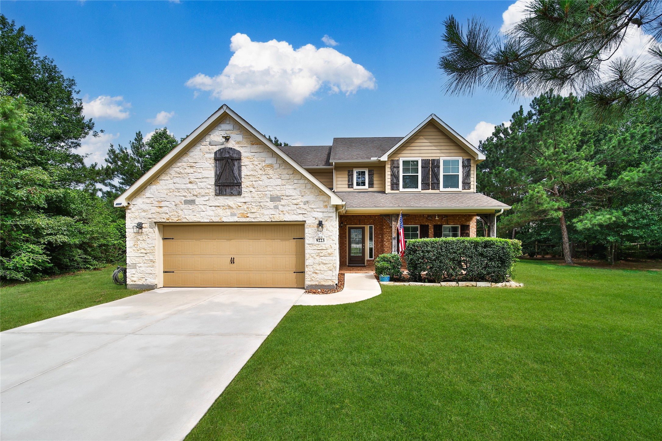 9223 Wapiti Trail Conroe, TX 77303 - Photo 1 of 45 a front view of a house with a yard and garage