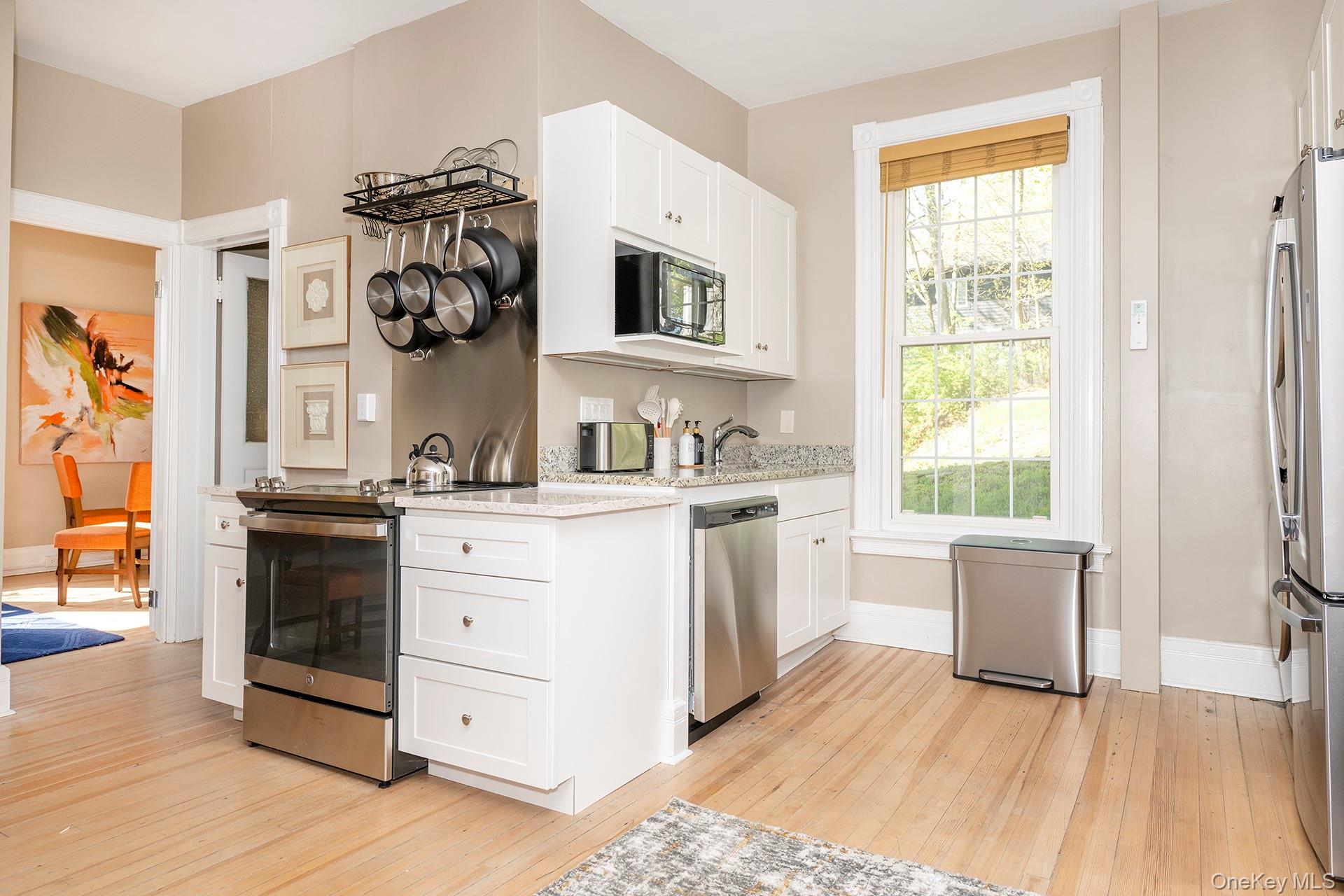 3212 Franklin Avenue, Unit 1ST FLOOR NORHT Millbrook, NY 12545 - Photo 4 of 11 a kitchen with a cabinets and wooden floor
