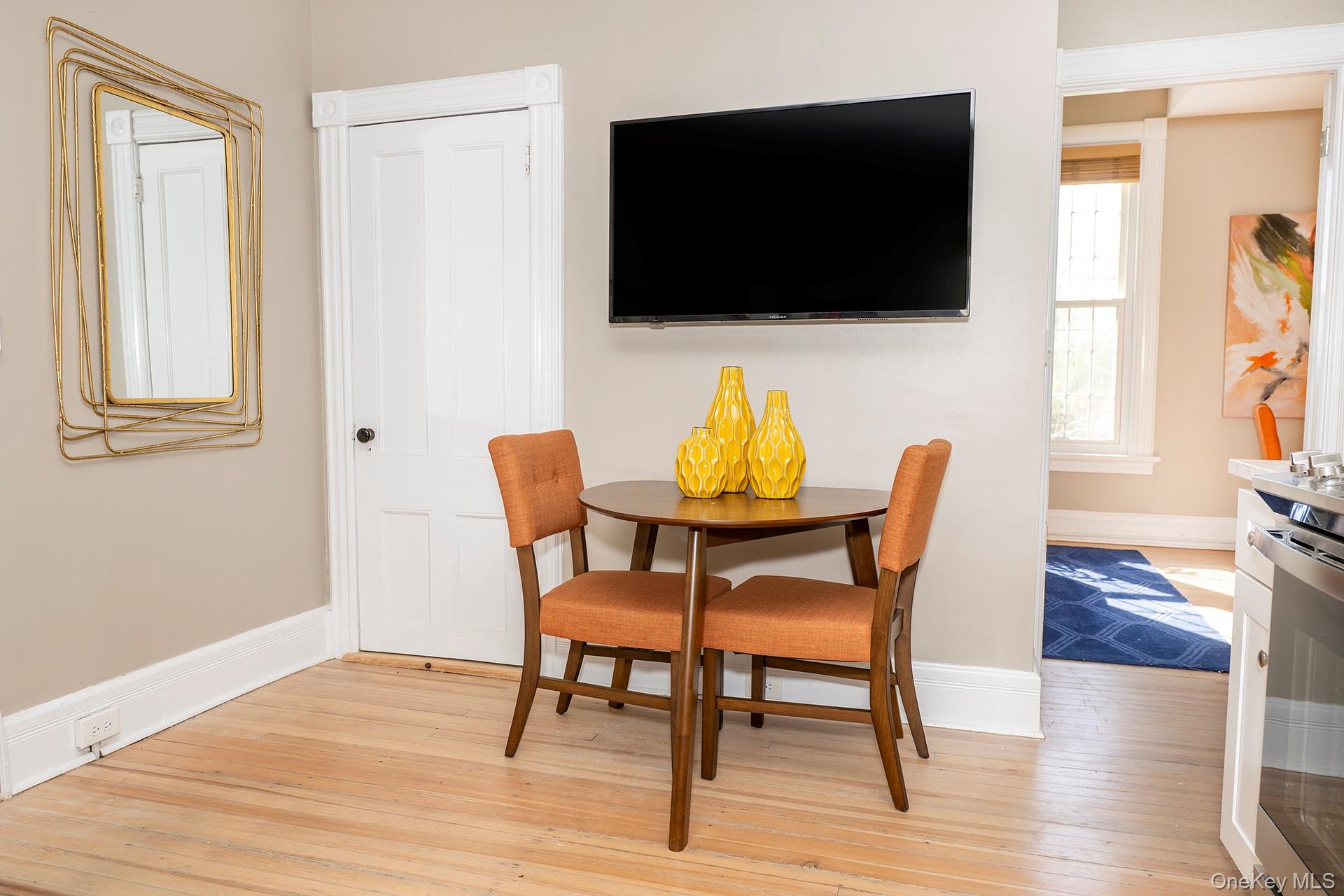 3212 Franklin Avenue, Unit 1ST FLOOR NORHT Millbrook, NY 12545 - Photo 5 of 11 a view of a dining room with furniture and wooden floor