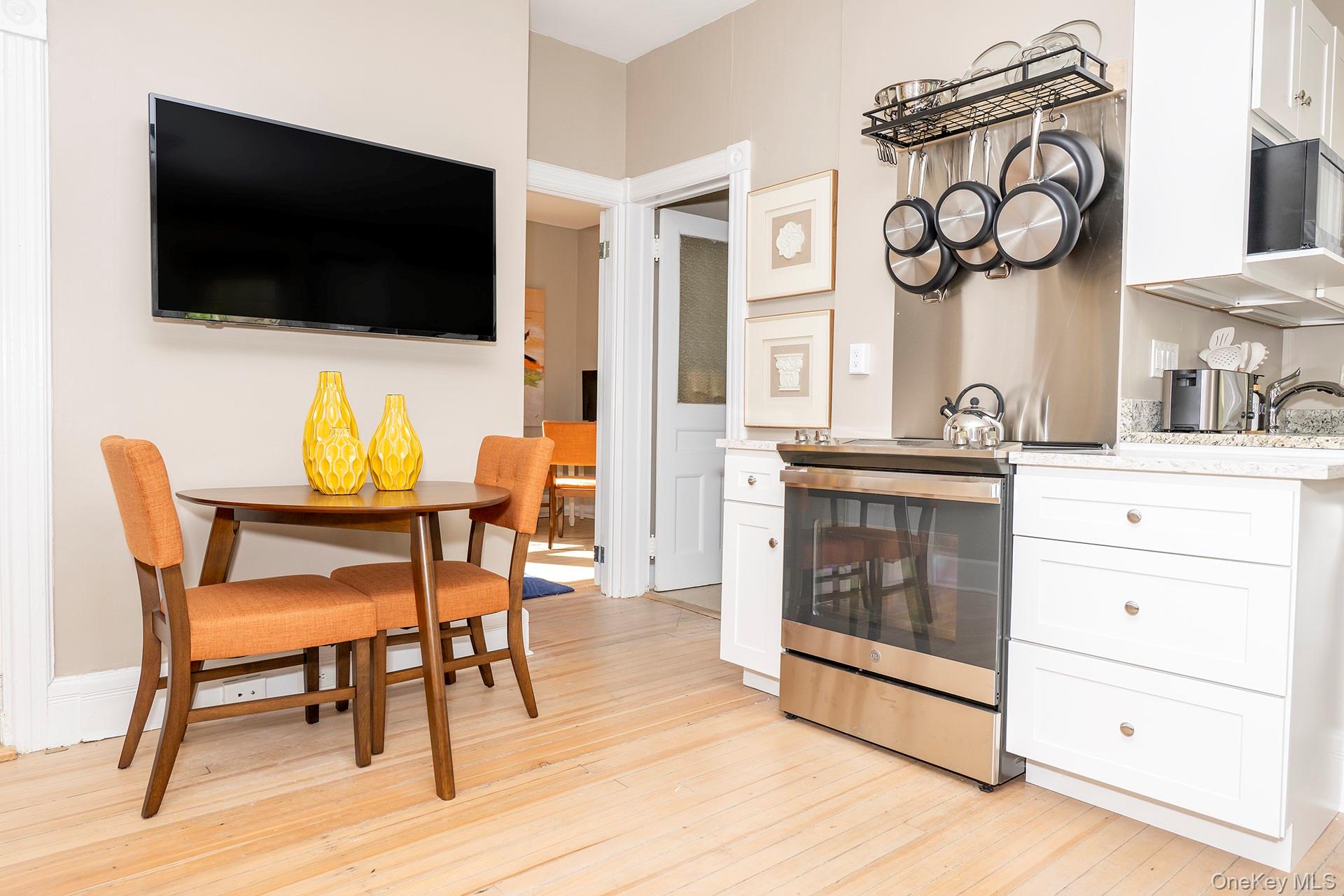 3212 Franklin Avenue, Unit 1ST FLOOR NORHT Millbrook, NY 12545 - Photo 6 of 11 a living room with furniture and a flat screen tv