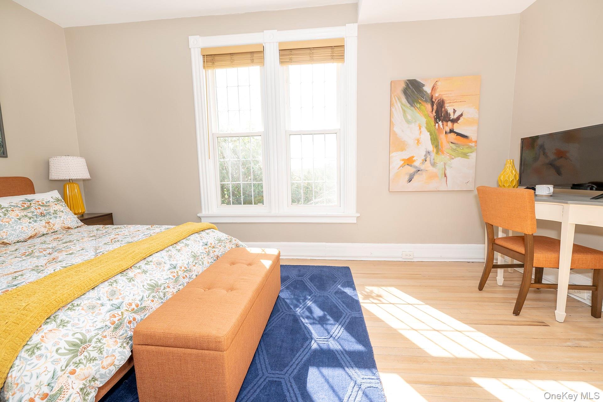 3212 Franklin Avenue, Unit 1ST FLOOR NORHT Millbrook, NY 12545 - Photo 8 of 11 a bedroom with a bed and a chair