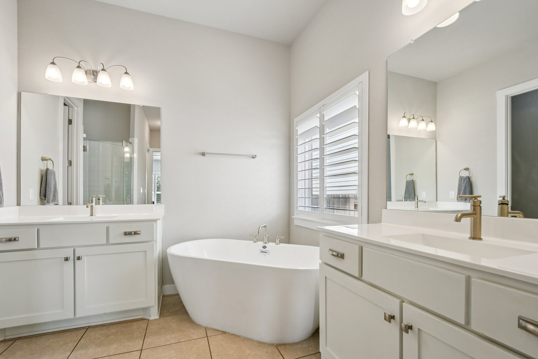520 Hazy Hills Loop Dripping Springs, TX 78620 - Photo 5 of 27 The spa-inspired primary bathroom features a tranquil design perfect for unwinding after a long day.