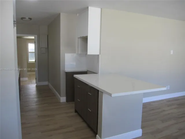 a kitchen with a sink and a refrigerator