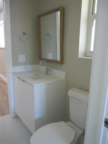 a white toilet sitting next to a bathroom sink