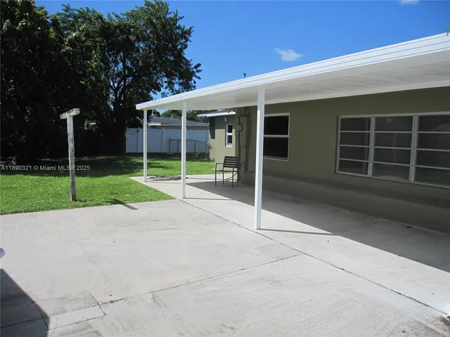 a view of an house with backyard and porch