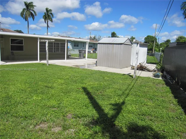 a view of a house with backyard sitting area and garden