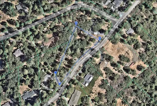 an aerial view of a houses with a yard