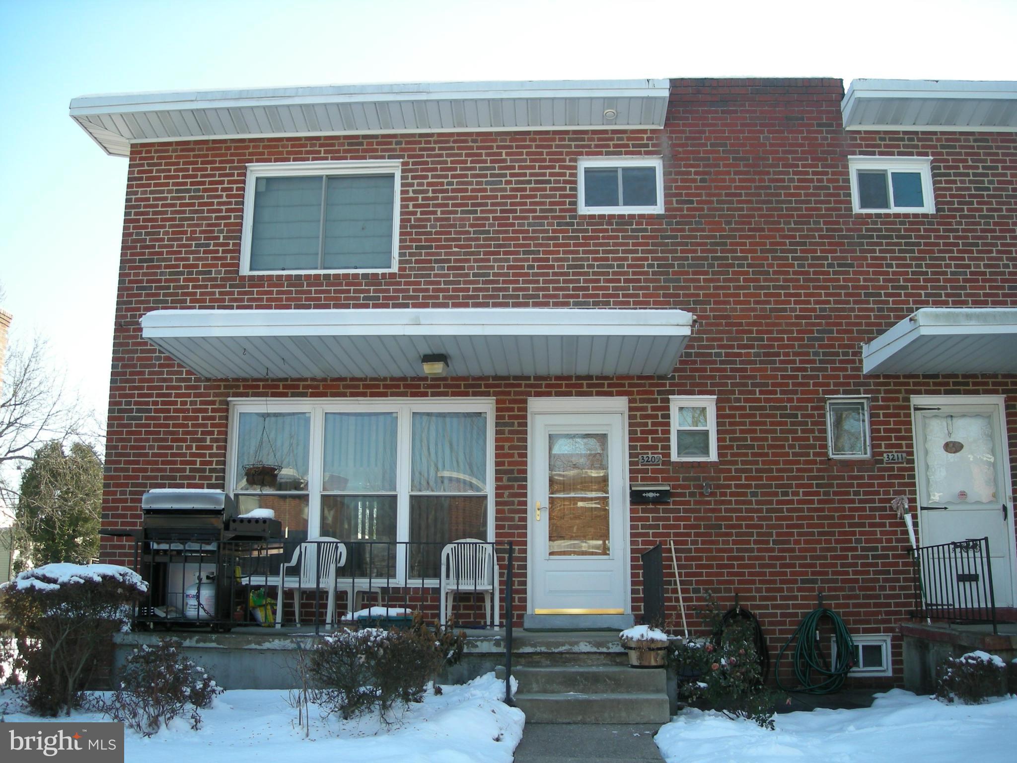 a front view of a house with outdoor seating