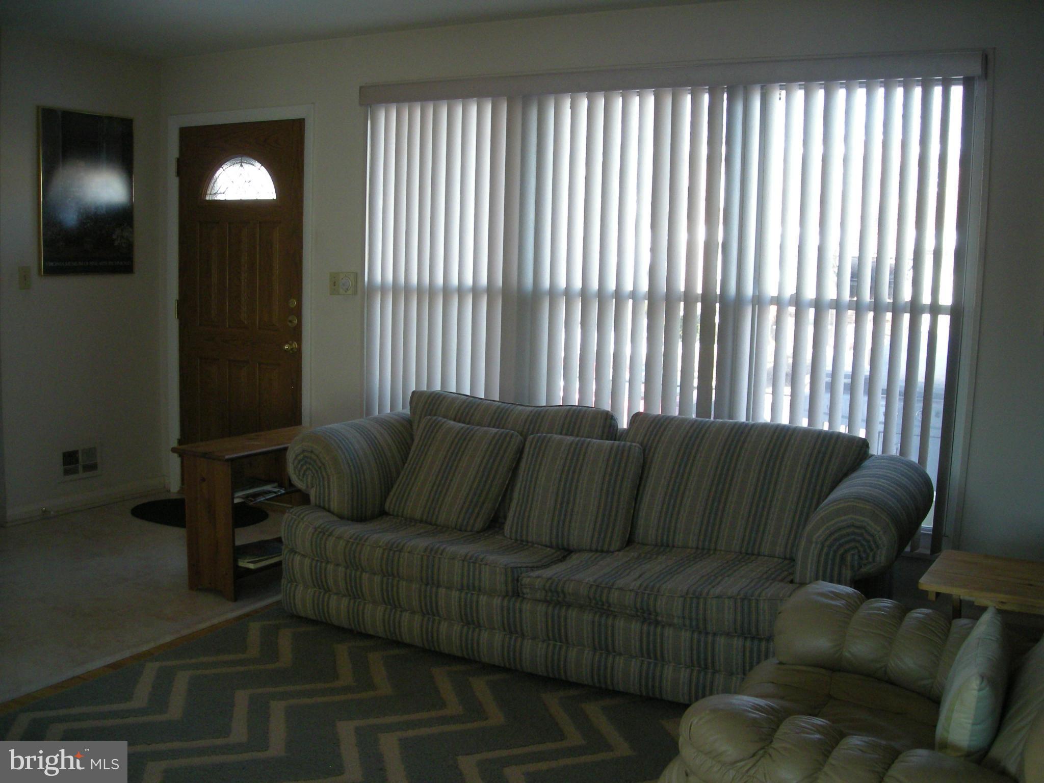 3209 Nerak Road Baltimore, MD 21208 - Photo 2 of 15 a living room with furniture and a lamp