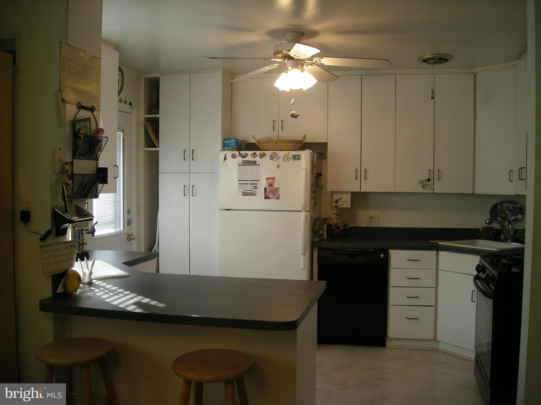 3209 Nerak Road Baltimore, MD 21208 - Photo 12 of 15 a kitchen with stainless steel appliances granite countertop a sink a stove and a refrigerator