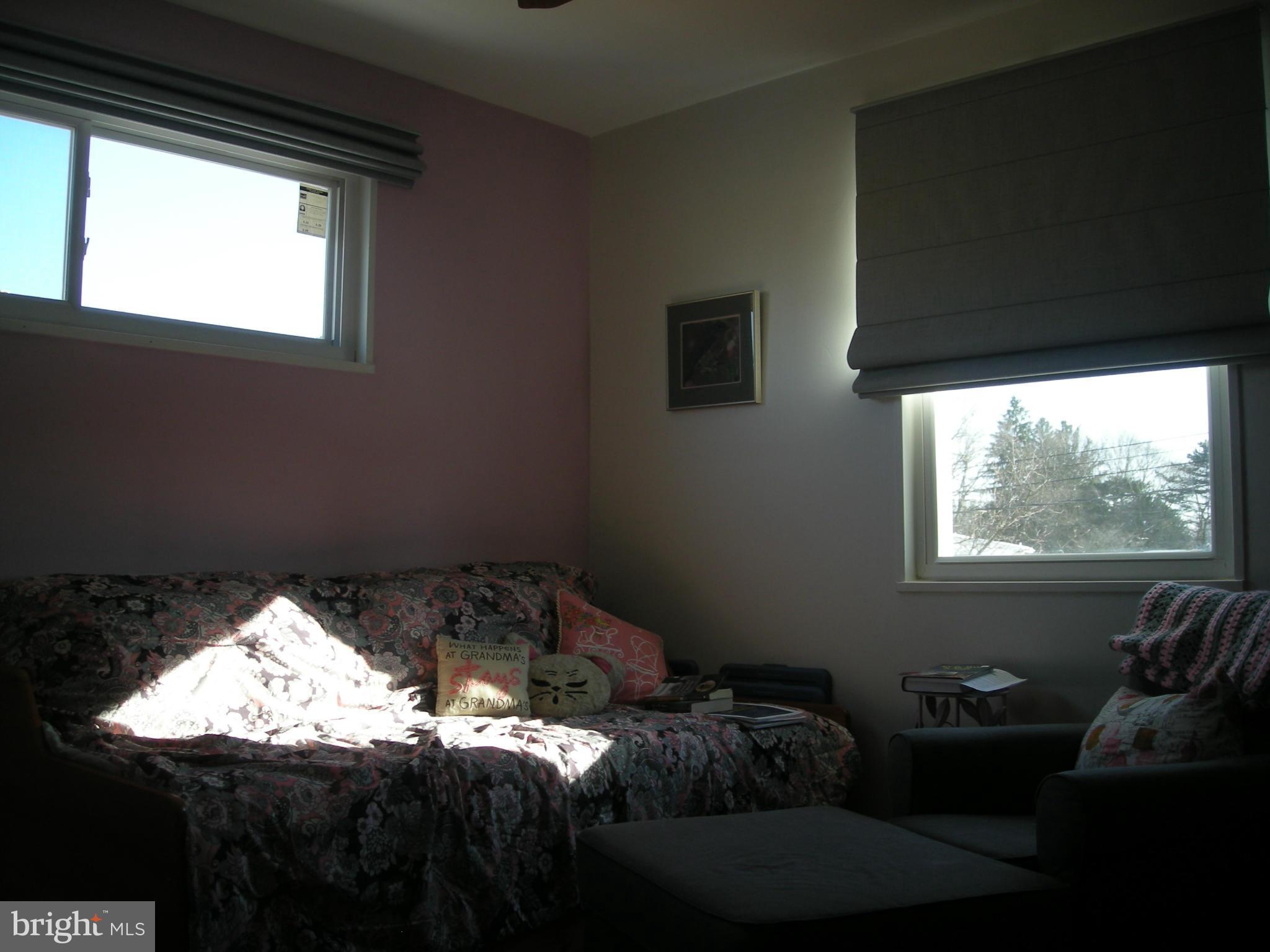3209 Nerak Road Baltimore, MD 21208 - Photo 14 of 15 a bed sitting in a bedroom next to a window