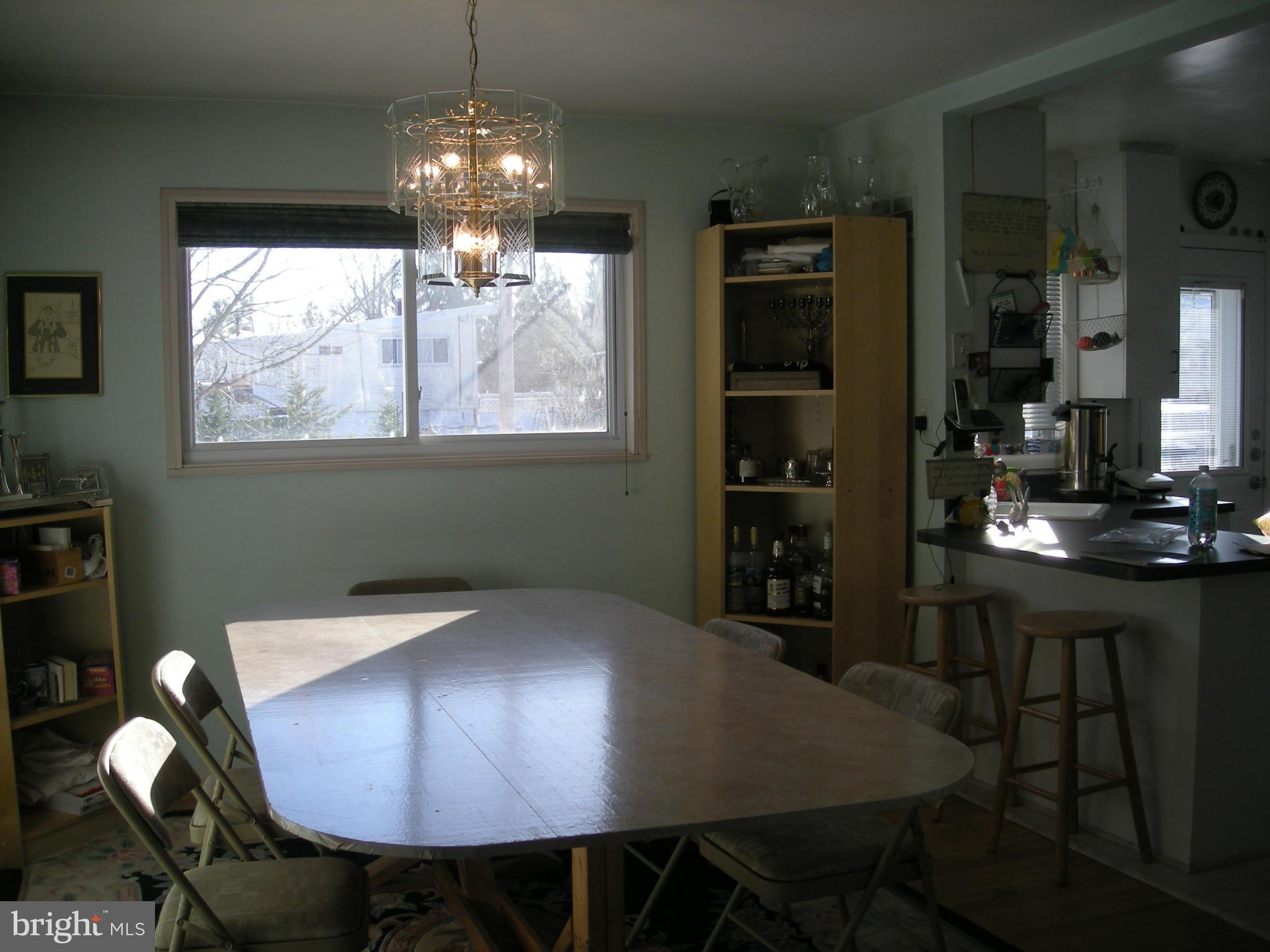 3209 Nerak Road Baltimore, MD 21208 - Photo 4 of 15 a view of a dining room with furniture window and wooden floor