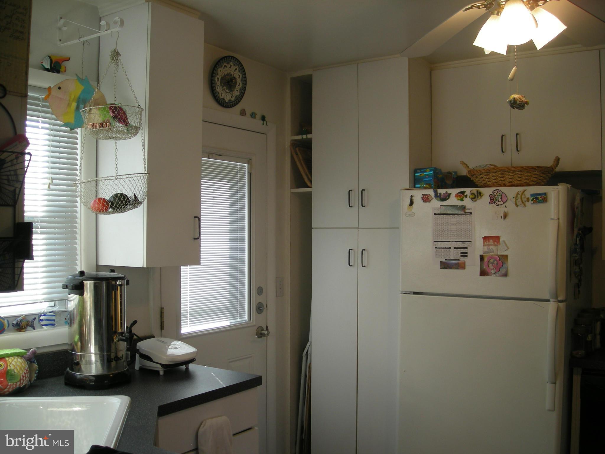 3209 Nerak Road Baltimore, MD 21208 - Photo 8 of 15 a bathroom with a refrigerator sink and mirror