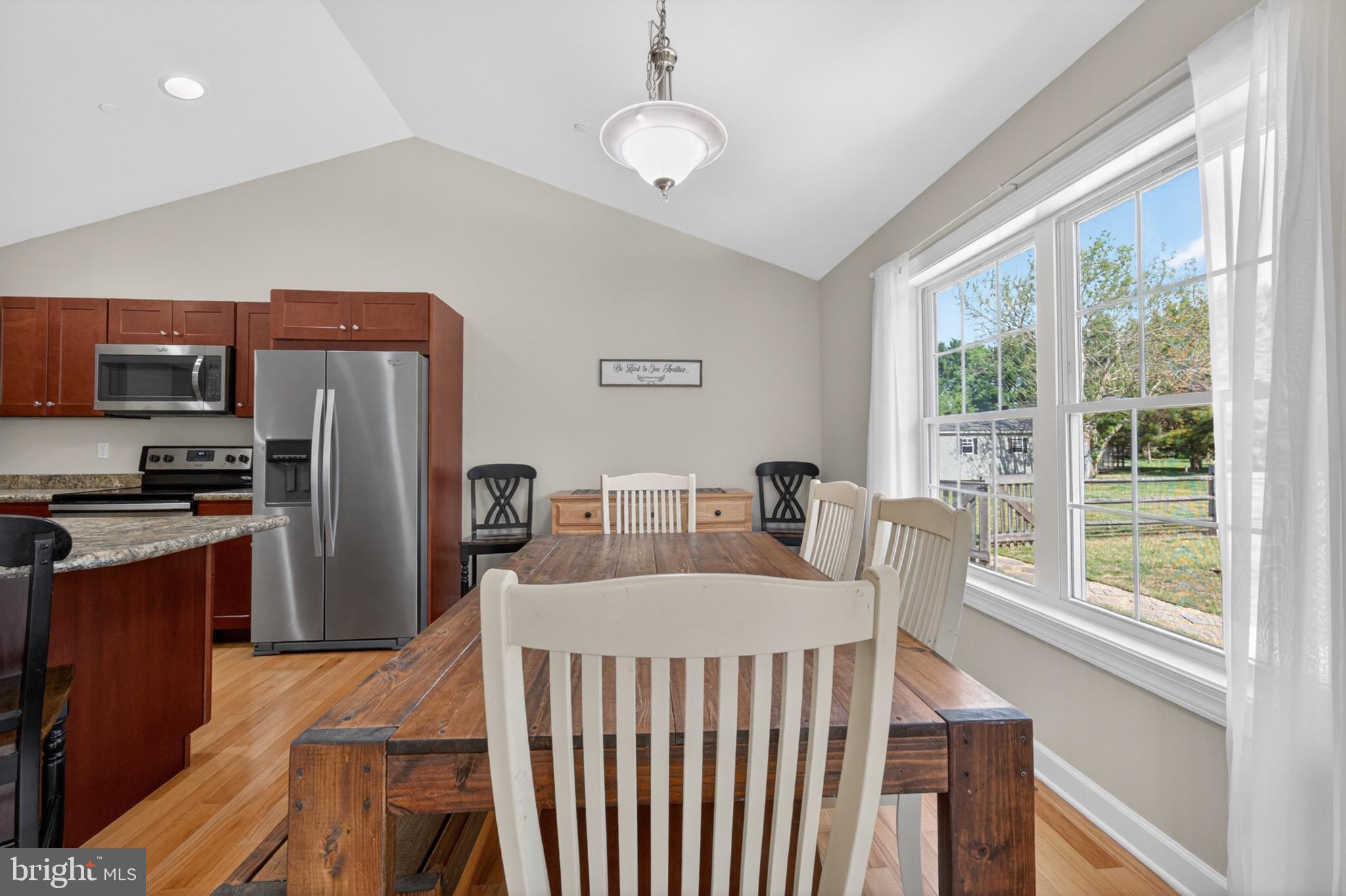 23283 Magnolia Hills Road Denton, MD 21629 - Photo 15 of 54 a living room with stainless steel appliances granite countertop furniture a fireplace and a large window