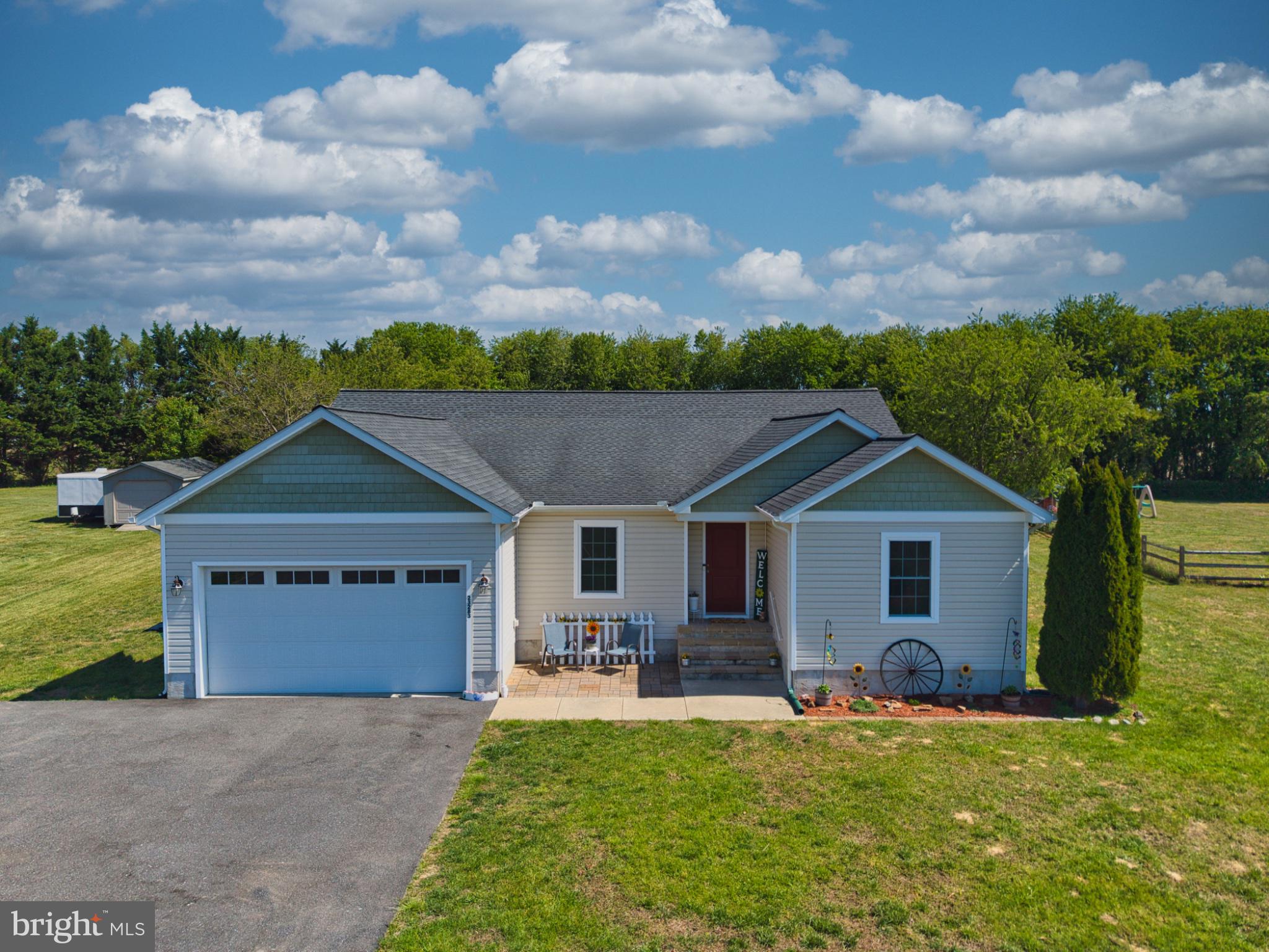 23283 Magnolia Hills Road Denton, MD 21629 - Photo 2 of 54 a front view of a house with a garden