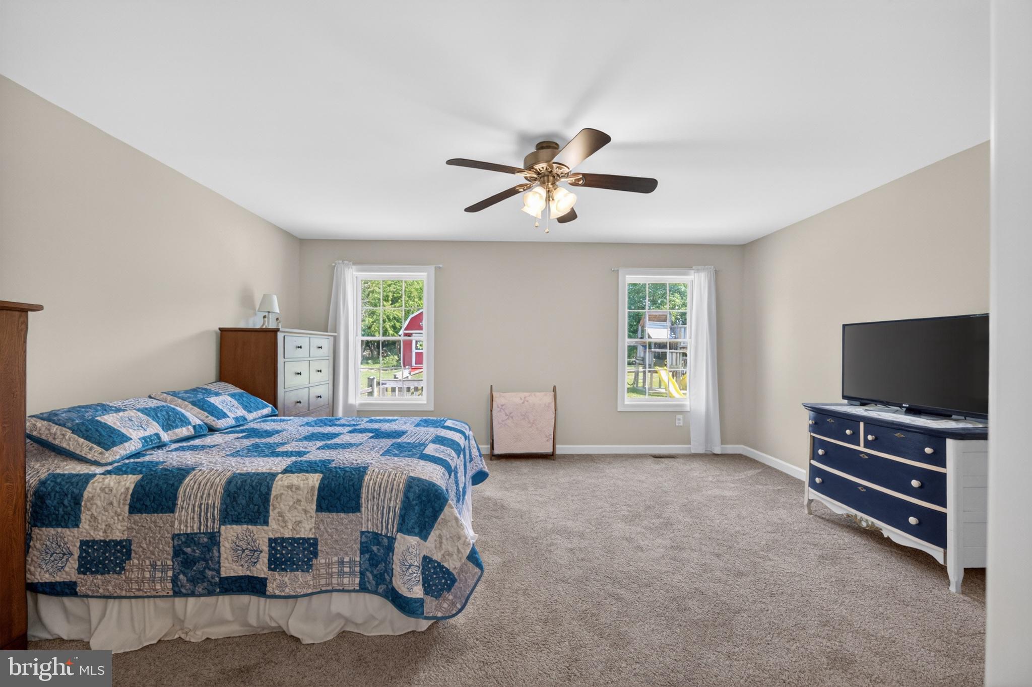 23283 Magnolia Hills Road Denton, MD 21629 - Photo 30 of 54 a bedroom with a bed and a flat screen tv