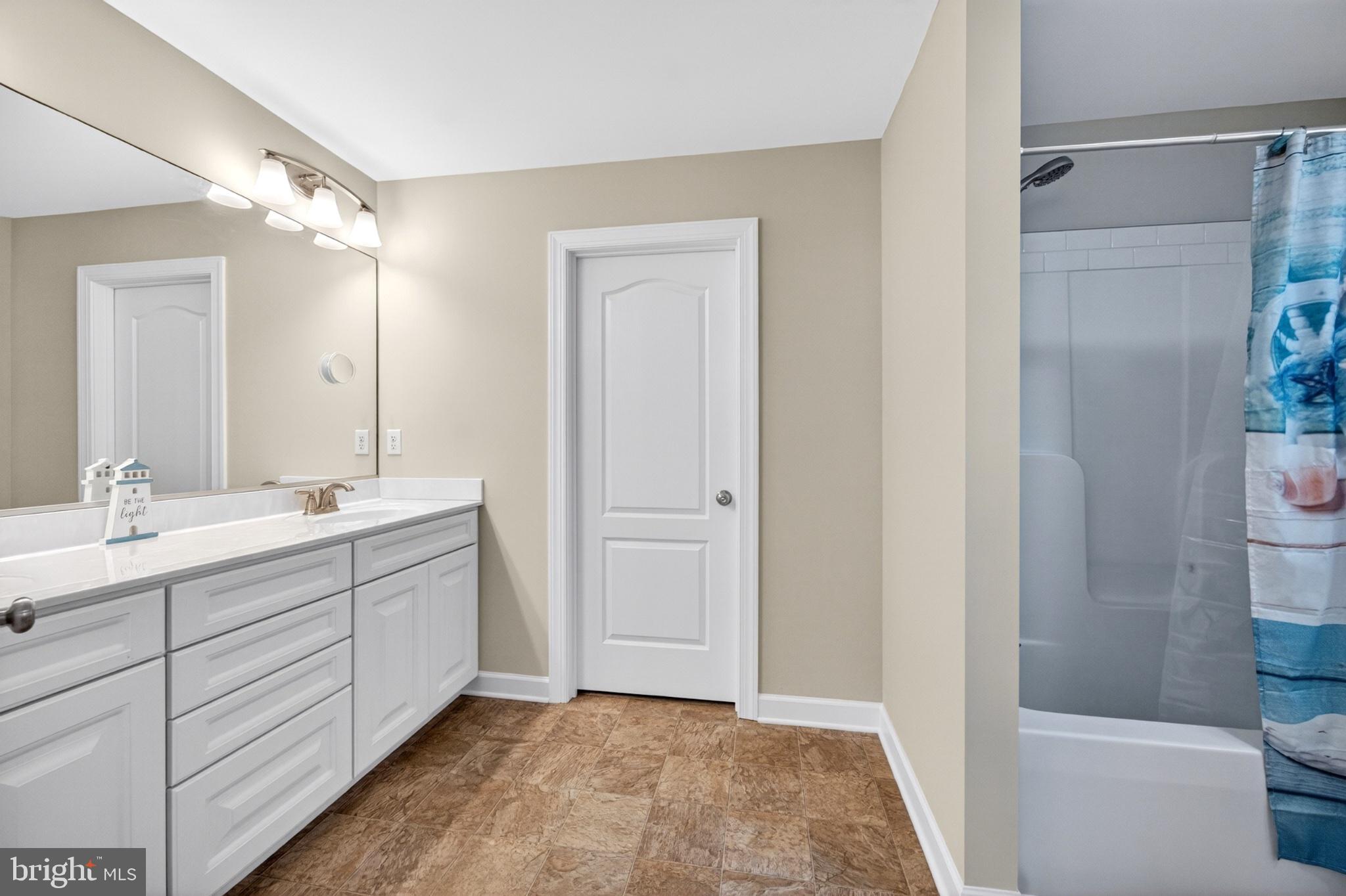 23283 Magnolia Hills Road Denton, MD 21629 - Photo 33 of 54 a bathroom with a double vanity sink mirror and shower