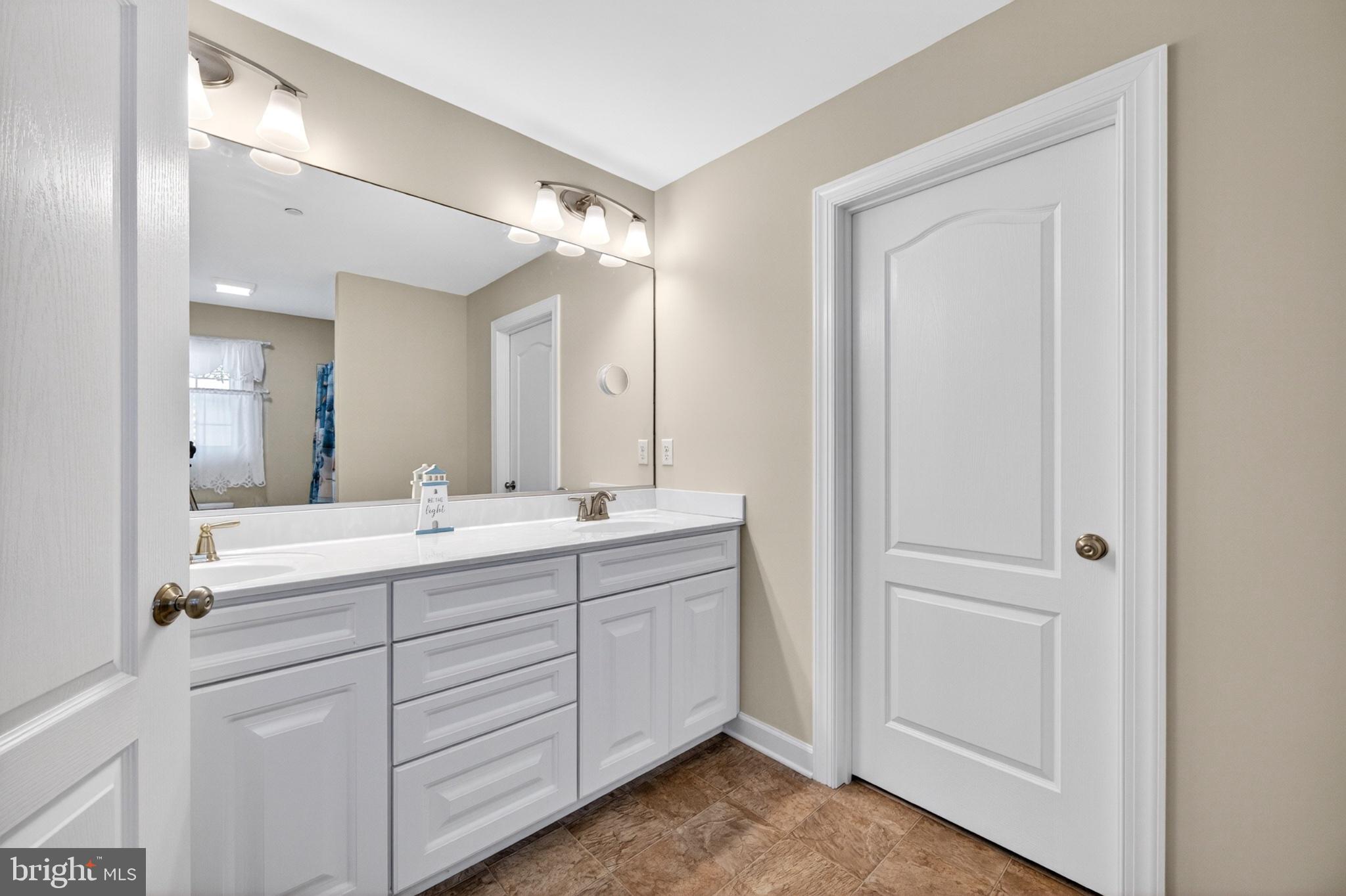 23283 Magnolia Hills Road Denton, MD 21629 - Photo 34 of 54 a spacious bathroom with a double vanity sink mirror and