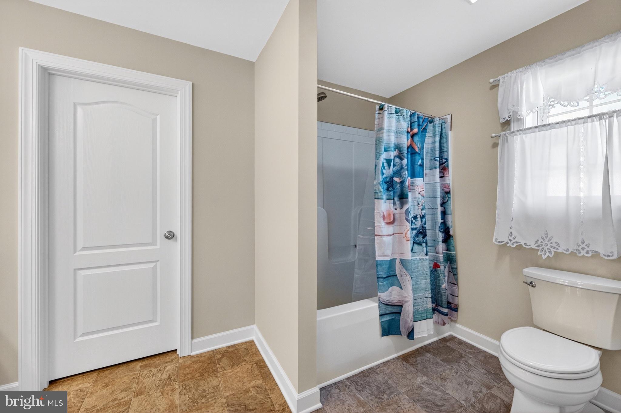 23283 Magnolia Hills Road Denton, MD 21629 - Photo 35 of 54 a bathroom with a toilet and a shower