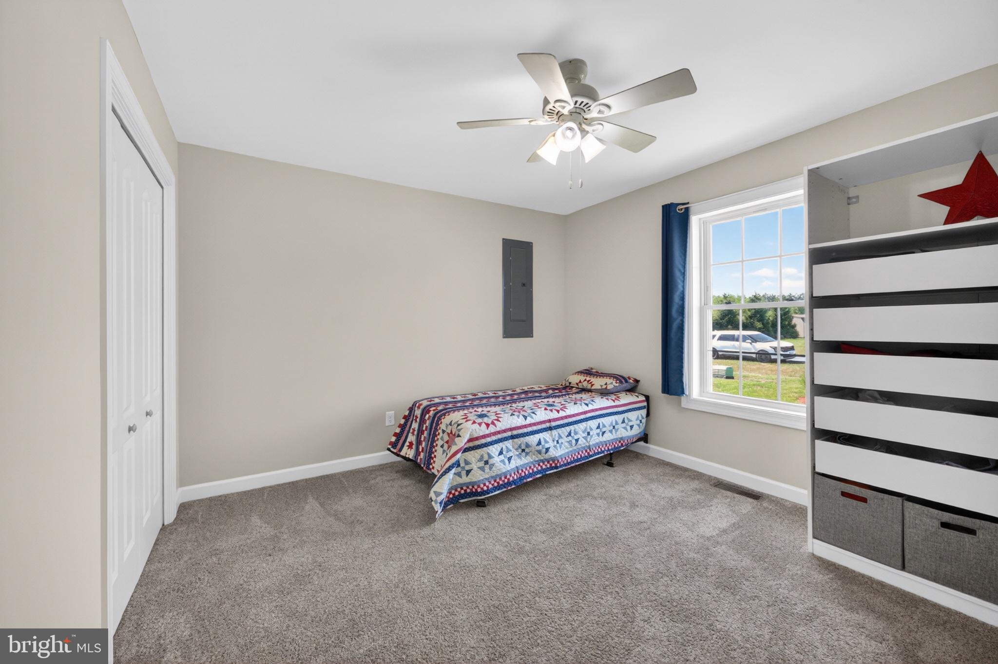 23283 Magnolia Hills Road Denton, MD 21629 - Photo 38 of 54 a spacious bedroom with a bed and a chandelier