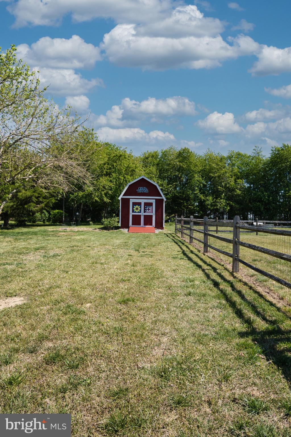 23283 Magnolia Hills Road Denton, MD 21629 - Photo 44 of 54 a view of a yard with wooden fence