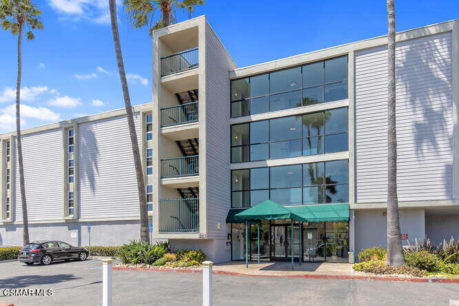 a front view of a building with a yard