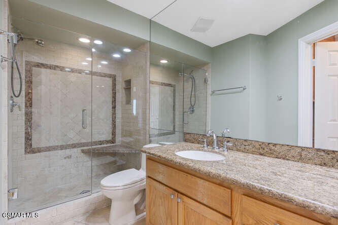 2901 Peninsula Road, Unit 348 Oxnard, CA 93035 - Photo 13 of 22 a bathroom with a granite countertop sink a toilet and shower