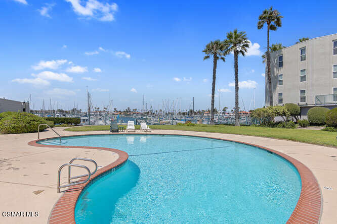 2901 Peninsula Road, Unit 348 Oxnard, CA 93035 - Photo 16 of 22 a swimming pool with outdoor seating and yard