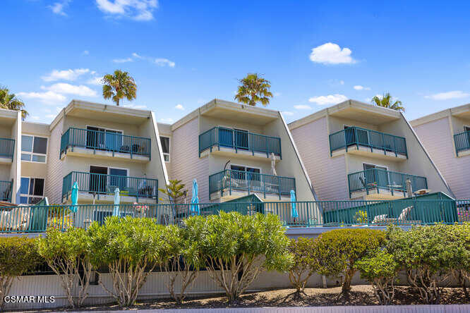 2901 Peninsula Road, Unit 348 Oxnard, CA 93035 - Photo 17 of 22 a front view of a multi story residential apartment building with a yard