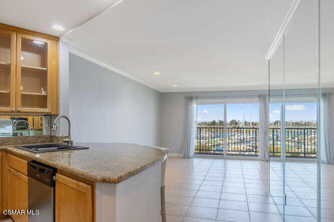 2901 Peninsula Road, Unit 348 Oxnard, CA 93035 - Photo 8 of 22 a kitchen with stainless steel appliances granite countertop a stove a sink and a refrigerator