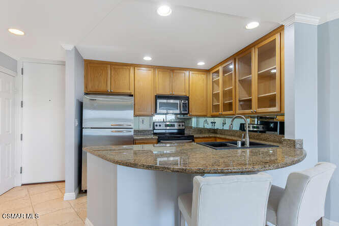 2901 Peninsula Road, Unit 348 Oxnard, CA 93035 - Photo 10 of 22 a kitchen with granite countertop a sink and cabinets