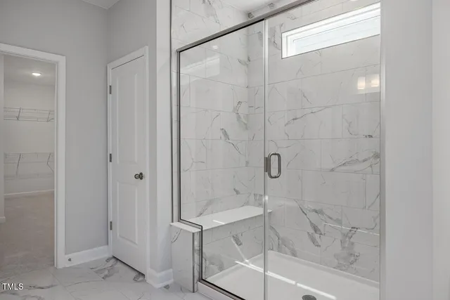 a white toilet sitting next to a bath tub