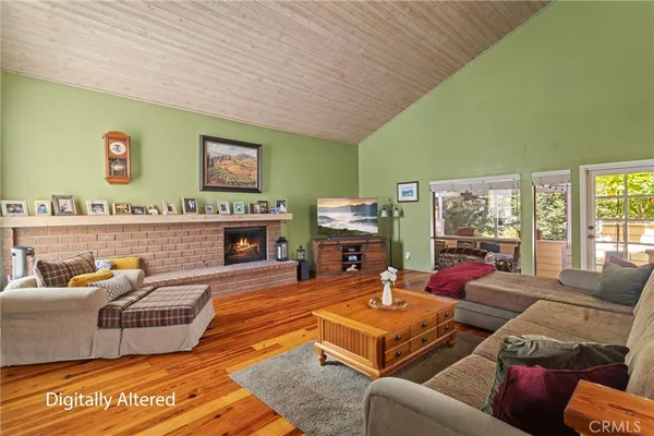 a living room with furniture a fireplace and a large window