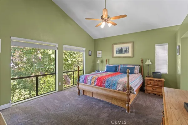 a spacious bedroom with a bed and a chandelier