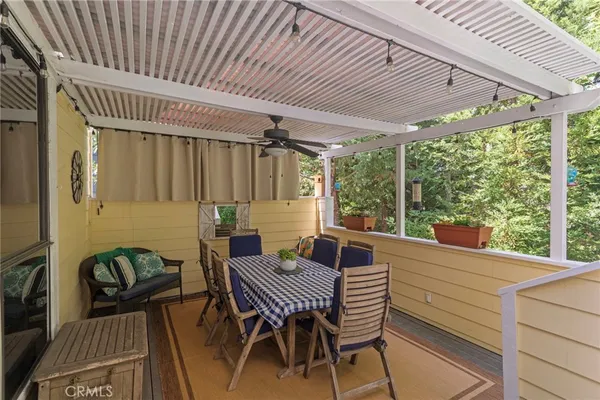 a view of a patio with a table chairs and backyard