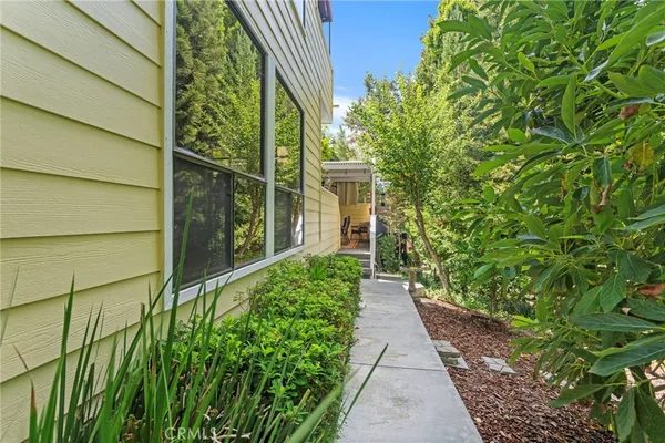 a view of a pathway both side of the house