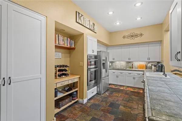 a kitchen with a refrigerator and cabinets