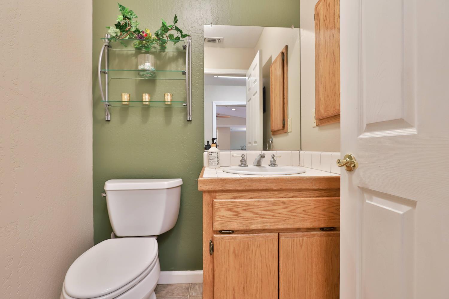 4773 Jacarah Road Placerville, CA 95667 - Photo 40 of 94 Powder room in main house next to laundry & door to garage