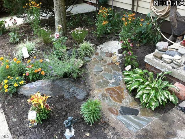 992 Hampton Ridge Drive Akron, OH 44313 - Photo 2 of 17 The front walk offers an area to make this space your own with pretty landscaping.