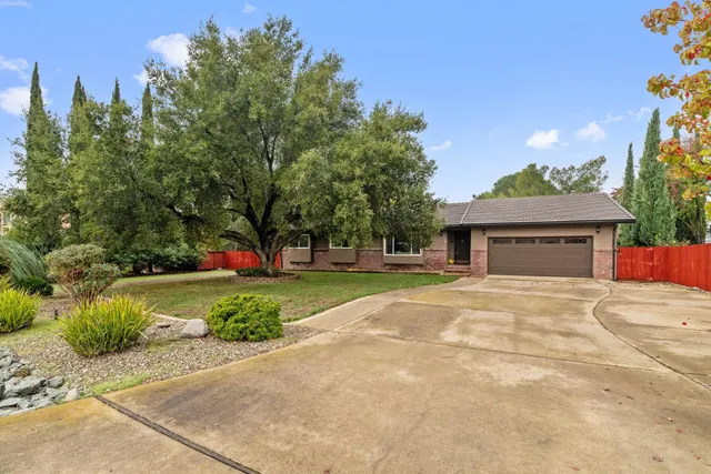 a front view of a house with a yard and a garage