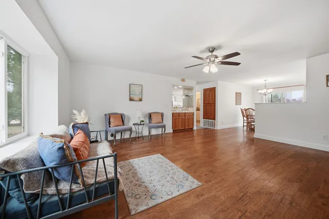 a living room with furniture and wooden floor