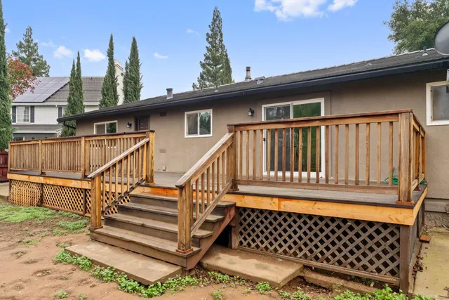 a view of a house with wooden deck